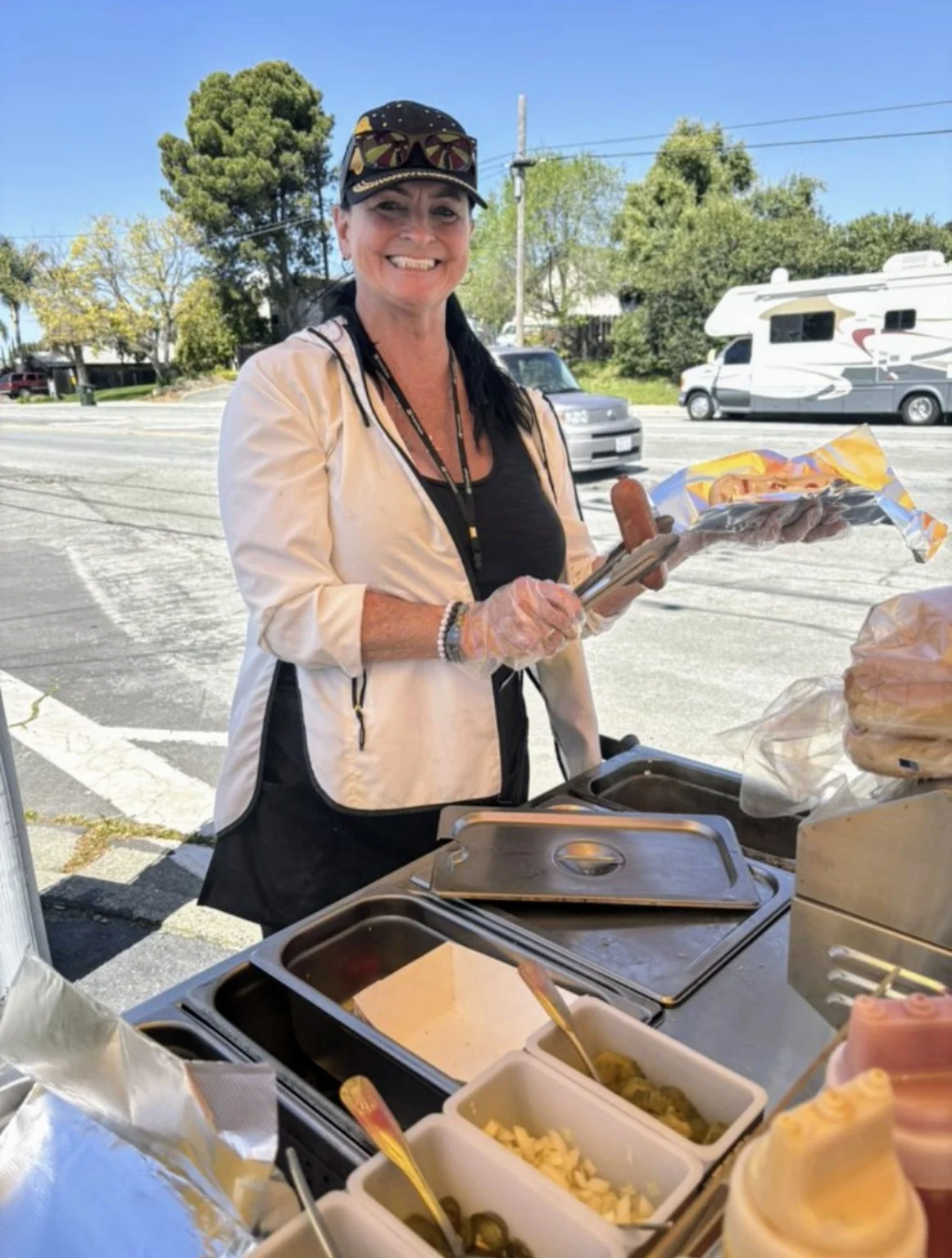 Lil serving from the hot dog cart